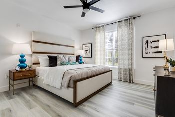 a bedroom with a bed and a ceiling fan